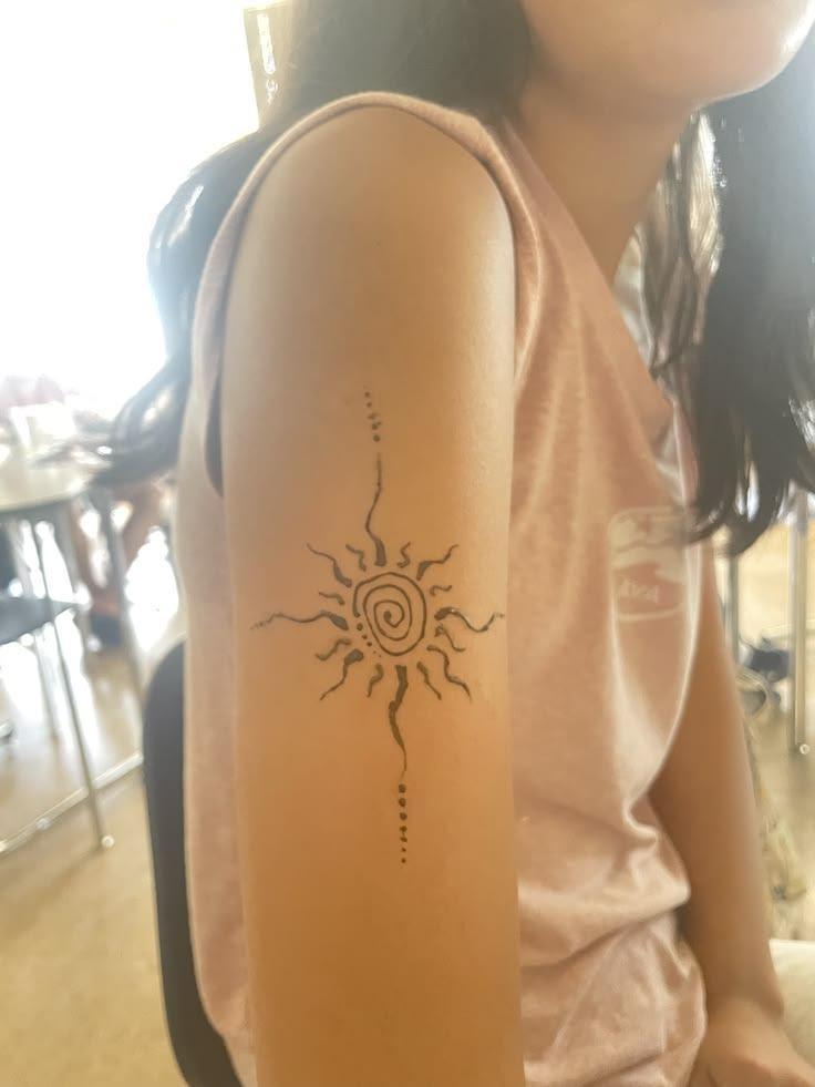 Sun Tattoo on the Upper Arm